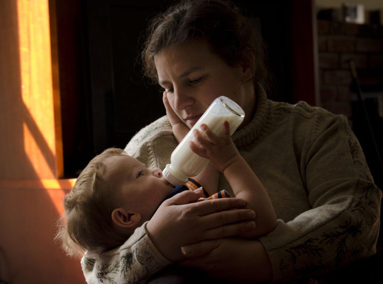 Father bottle-feeding his baby