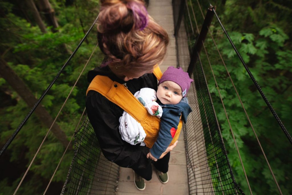 Mother carrying her baby in a soft-structured carrier