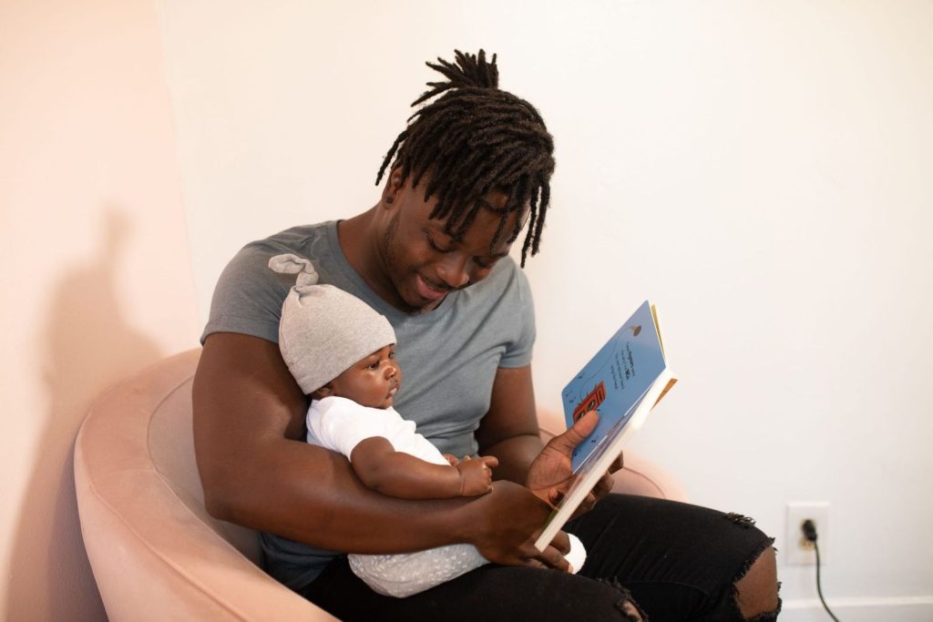 Father reading a picture book to his baby
