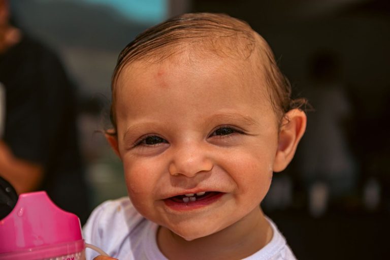 Smiling baby showing new teeth