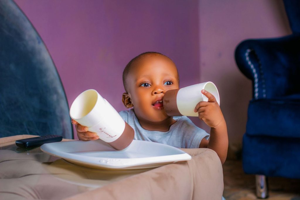 Baby playing with cups indoors