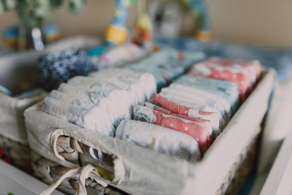 Neatly organised diapers in a woven basket