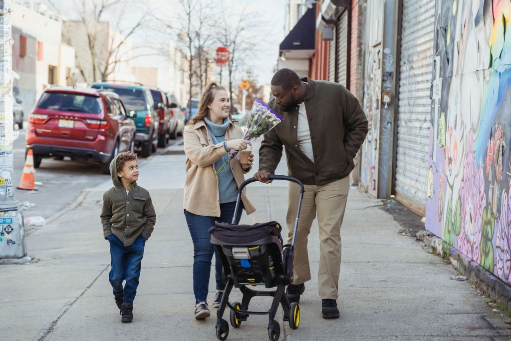 Family walking down the street with a stroller