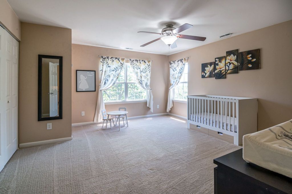 Calm, bright nursery with a white crib